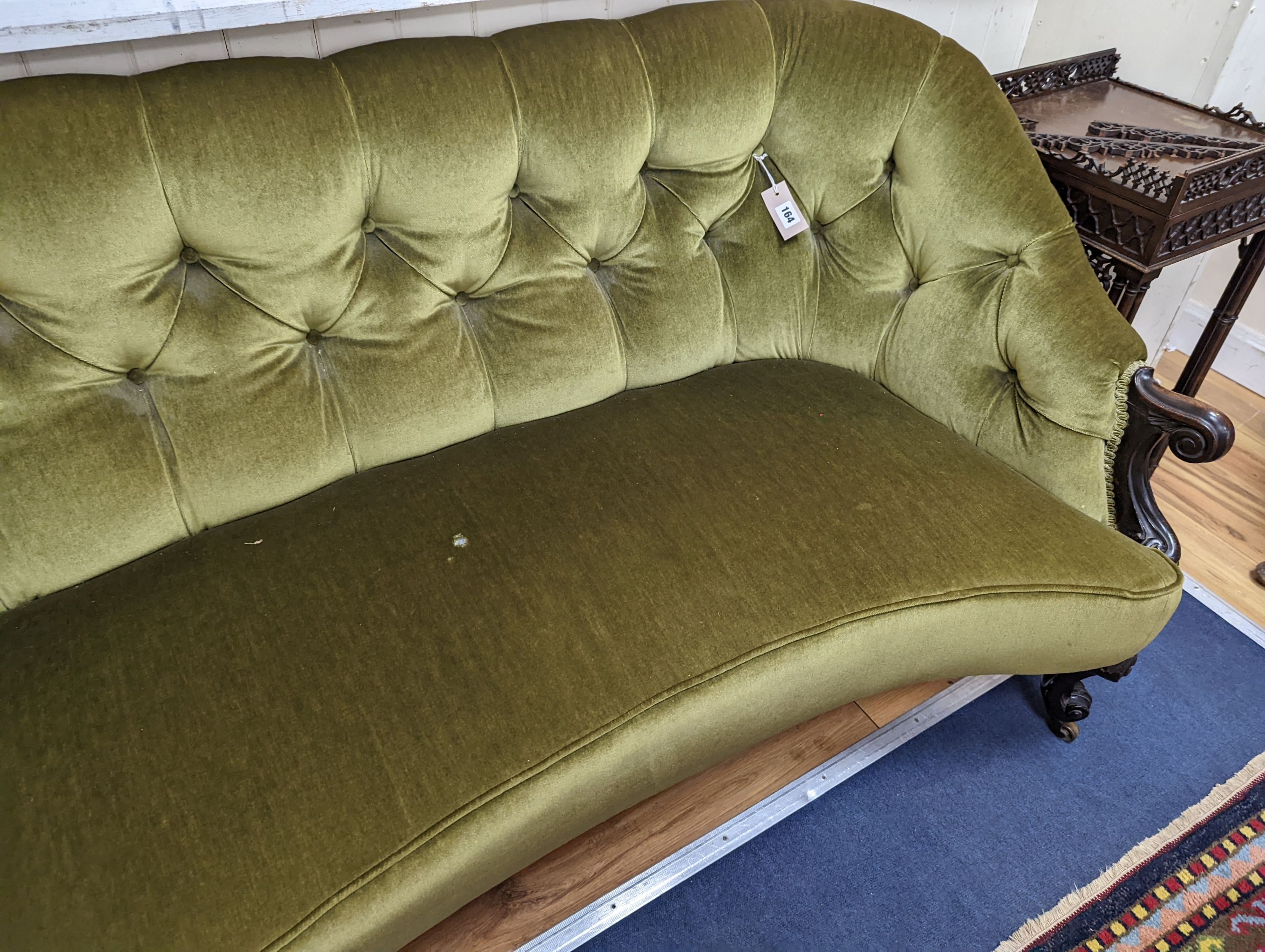 An early Victorian rosewood concave fronted two seat settee upholstered in buttoned green dralon, length 156cm, depth 77cm, height 80cm